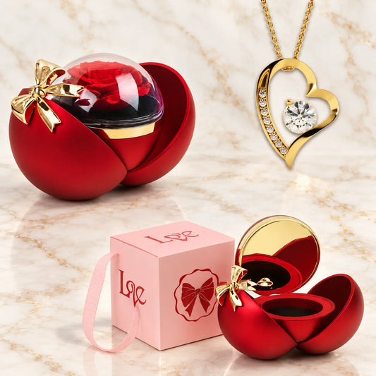 Rote Kugelbox mit Rose, goldene Herzkette mit Zirkonia und rosa Geschenkverpackung mit Schleife im Überblick